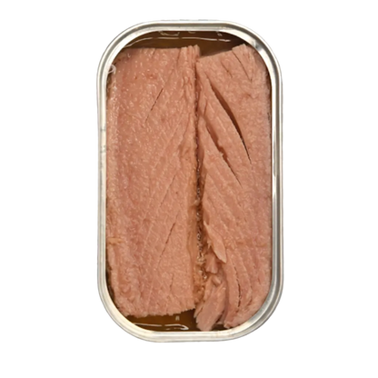 An open metal can of sliced pink fish, likely tuna, showing the flaky texture of the meat inside, isolated on a gray and white checkered transparency background.