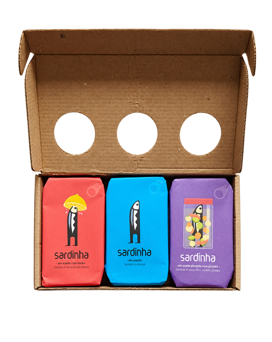 Open Sardinha gift box with red lemon, blue olive oil and purple spicy pickles sardine tins